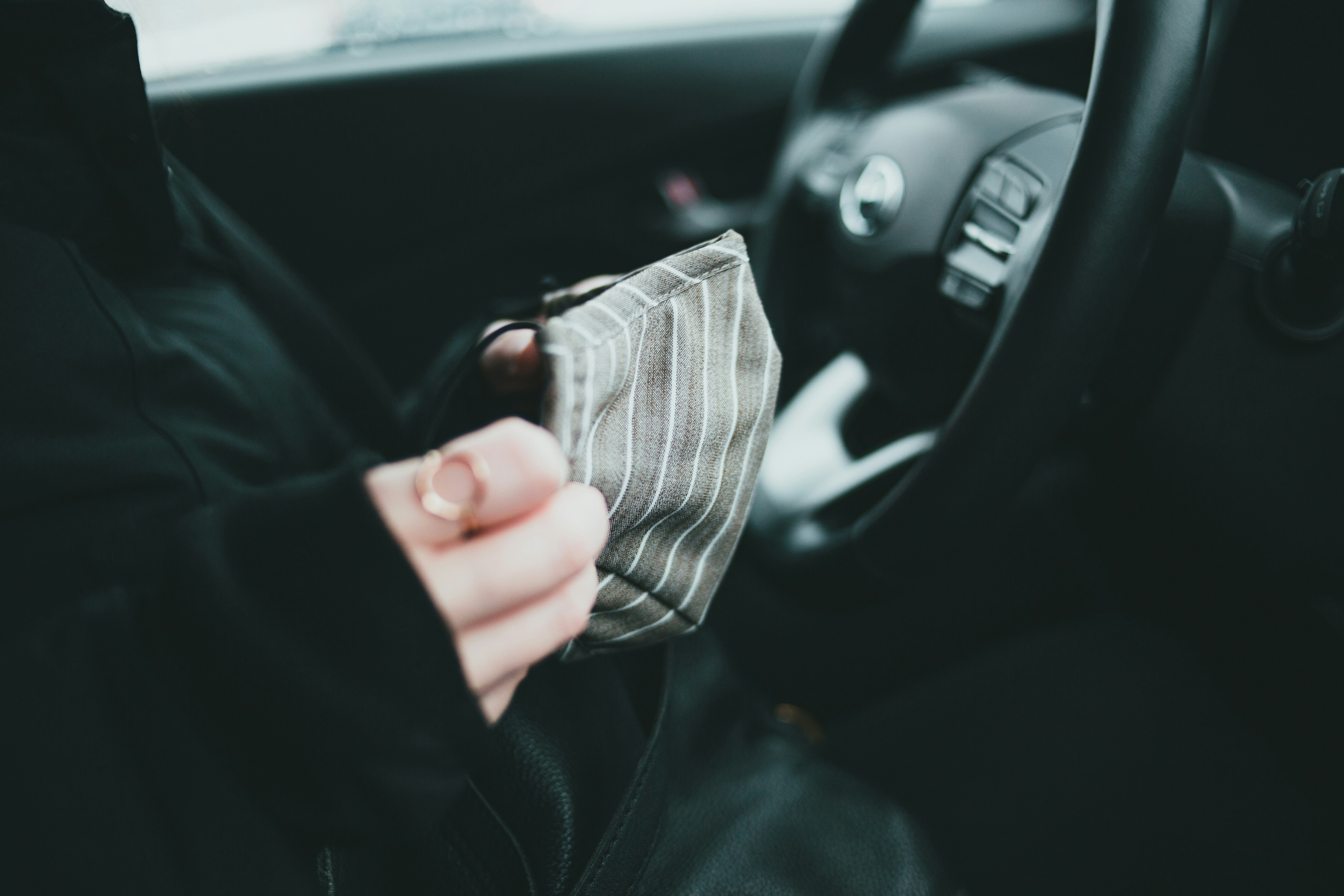 person holding white and black striped textile